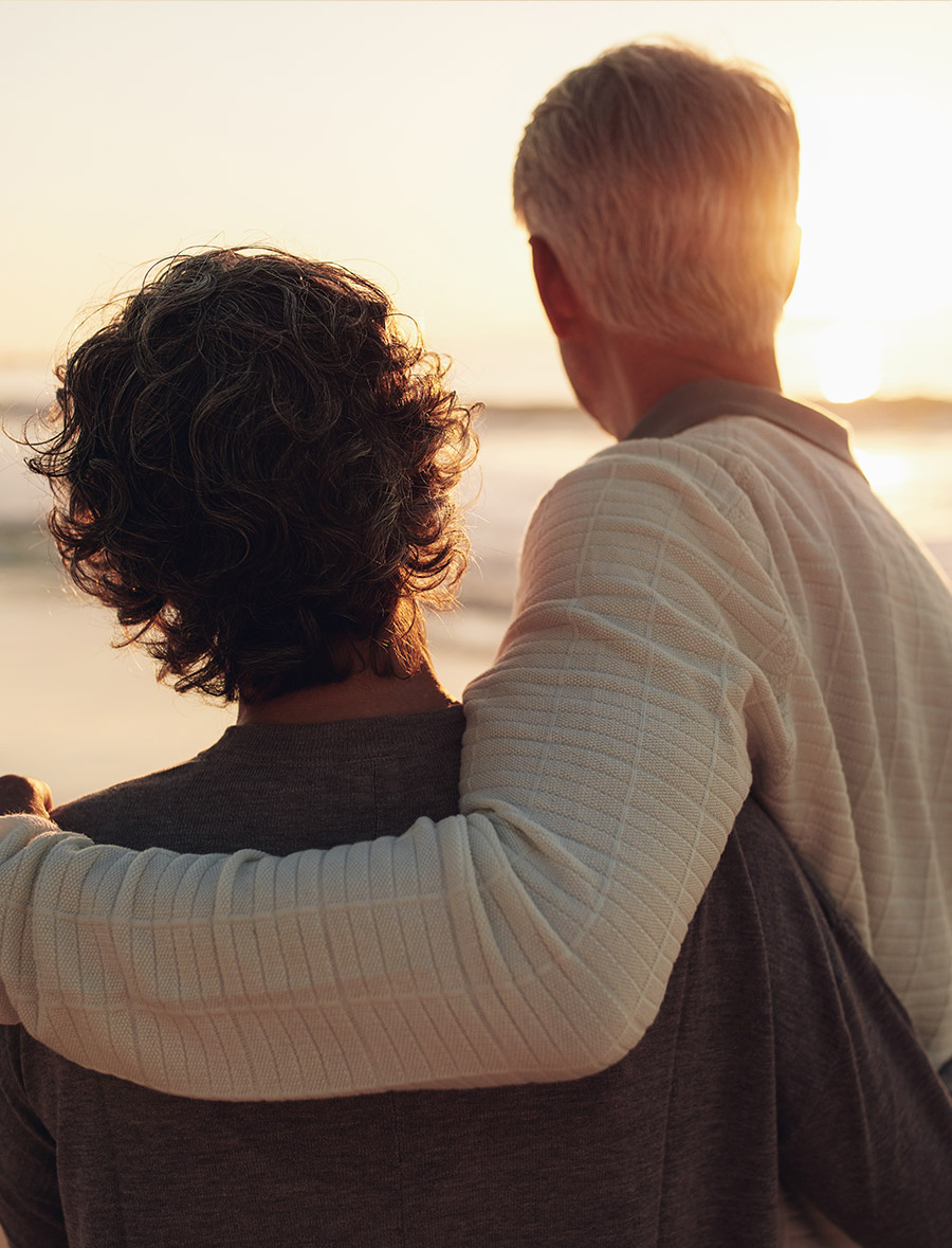 Couple standing in front of a sunset